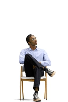 A man in a gray shirt, on a white background, is sitting on a chair.