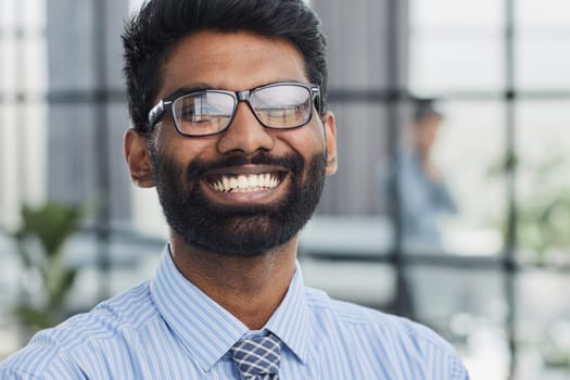 male investor beard looking at camera and smiling in modern office