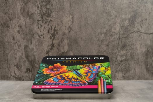 Burriana, Spain 12-30-2023: Product image of a metal box of colored pencils from the Prismacolor brand on a gray background.