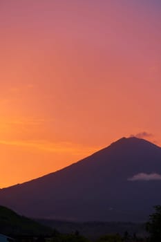 Silhouette of the Agung volcano at sunset. Panorama of the mountain on the island of Bali