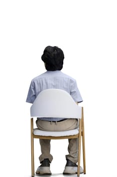 A guy in a blue shirt, on a white background, is sitting on a chair.