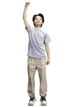 A guy in a gray T-shirt, on a white background, in full height, raised his hand up.