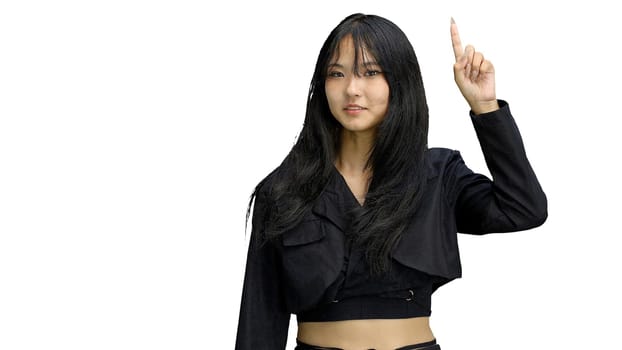 A girl in black clothes, on a white background, close-up, pointing up.