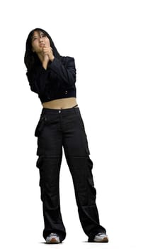 A woman in black clothes, on a white background, full-length, dreaming.