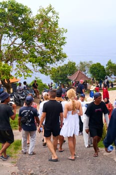 A crowd of tourists visits a popular place on an island in Indonesia. Bali, Indonesia - 01.01.2023