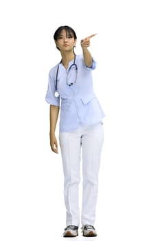 The doctor's girl, on a white background, in full height, points to the side.