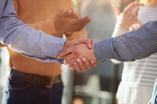 Closeup of business shaking hands over a deal