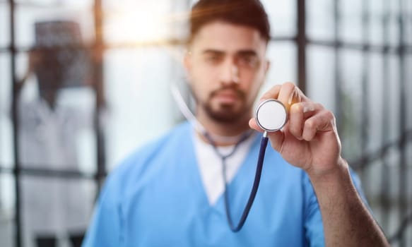 A futuristic doctor shows stethoscope and appear of advanced futuristic medicine symbols in holography.