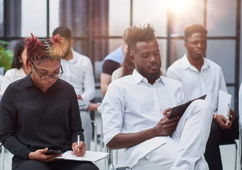 a group of people at a lecture listening attentively to the speaker