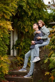 Joyful Autumn Embrace: Cute Lovers Strolling in the Park. Young Cute Female Hugs Boyfriend. In Autumn Outdoor. Lovers Walking in Park. Attractive Funny Couple. Lovestory in Forest. Man and Woman. Cute Lovers in the Park. Family Concept. Happy Couple.