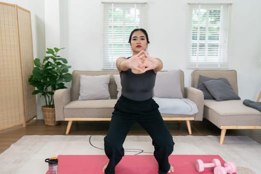 Cheerful attractive young overweight woman in activewear choosing healthy lifestyle.