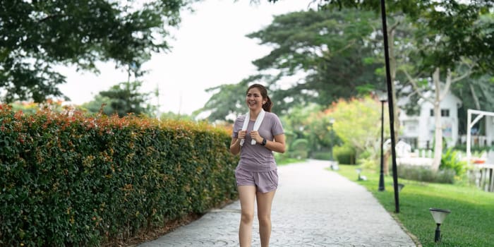 Women runner wearing sport cloths jogging in morning at park. Active morning.