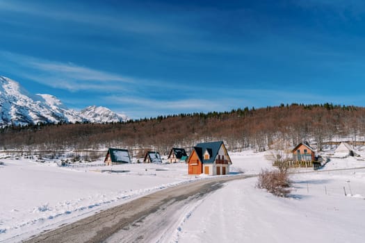 Colorful cottages in Durmitor National Park at the foot of the snowy mountains. Montenegro. High quality photo