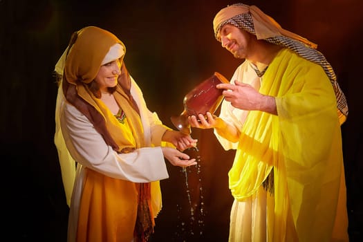 A couple in love or a married couple in stylized Eastern clothing from Israel, Palestine, Iran, Pakistan together. Tender photo session in the style of the Middle East and the Bible