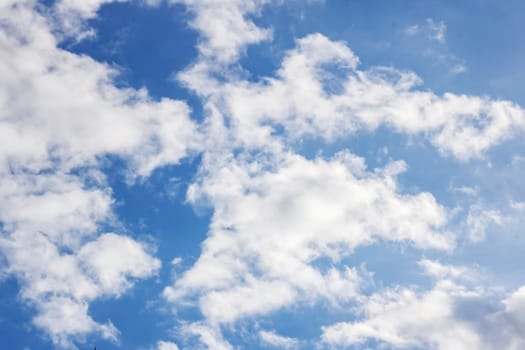 White clouds and blue sky background for text or texture