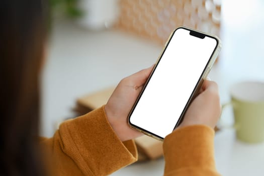 Closeup woman hands holding mobile phone with empty screen for application advertising