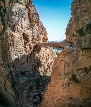 Caminito Del Rey, a breathtaking cliffside path featuring a bridge over a rock canyon, is a popular tourist attraction in Malaga, Spain.