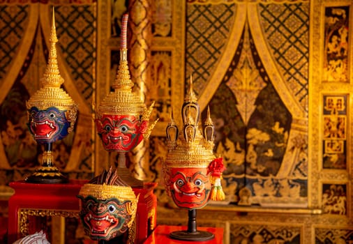 Close up beautiful ancient traditional Thai pattern Pantomime or Khon masks are set up on wooden shelves