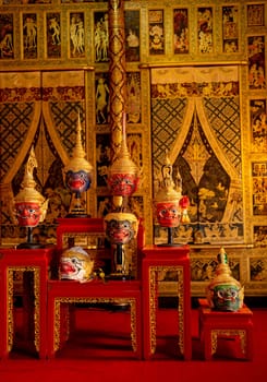 Vertical of beautiful ancient traditional Thai pattern Pantomime or Khon masks are set up on wooden shelves