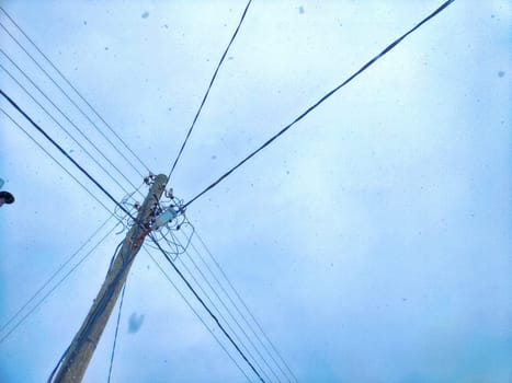 Old pole with wires against the sky. Electric transmission line, Eco-friendly energy