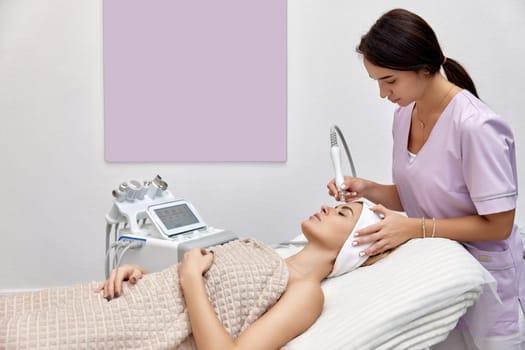 cosmetologist doing anti aging procedure in beauty salon