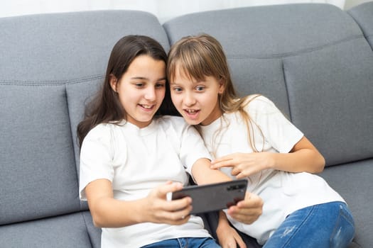 little children with a phone in their hands playing games. High quality photo