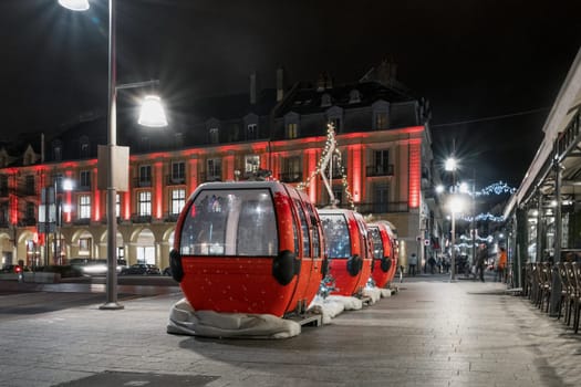 Urban night landscape with cable cars as scenery and illuminated lamps