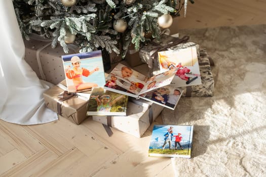 Photo printing, Christmas family memories. Small boy looking at Christmas printed photos. High quality photo