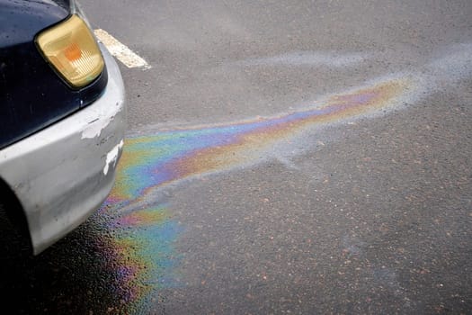 Motor oil stains leak out from under an old car. Leak under the car when the car is stationary.