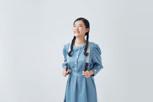 Beautiful fashionable woman in nice dress with backpack on white