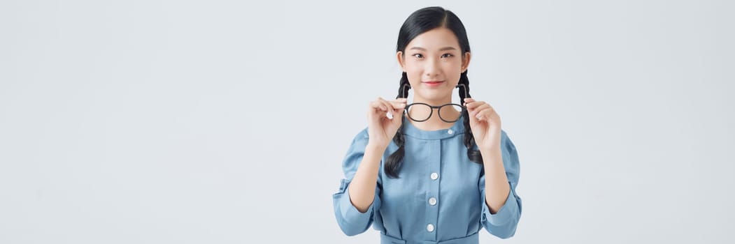Poor eyesight concept. Girl holds glasses for sight in her hands.