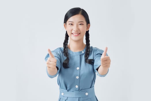 Beautiful happy student girl smiling and showing thumbs up gesture