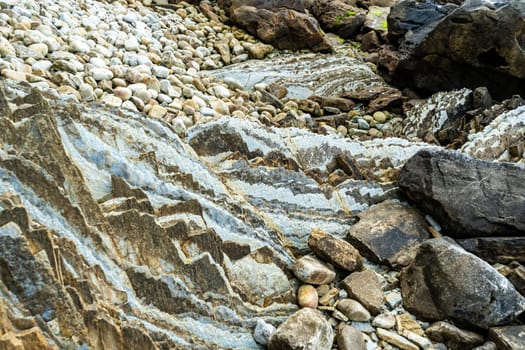 Rocky ocean shore. Pebbles and boulders on the seashore