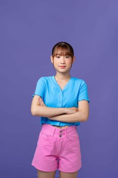 Image of a happy cheerful young pretty woman posing isolated over purple background looking aside.