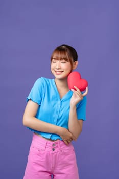 Beautiful girl holding heart shape