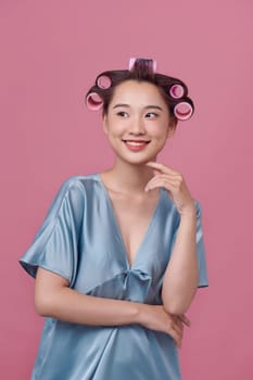 Portrait of young woman wearing hair rollers