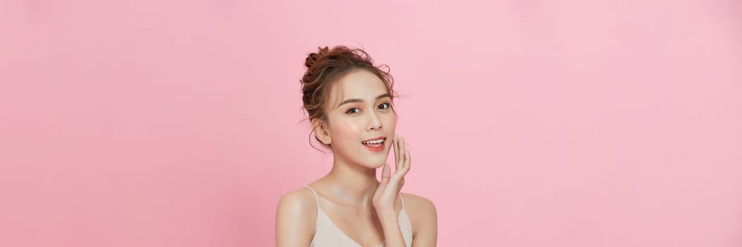 Young Asian beauty woman with korean makeup style on face on isolated pink background. 