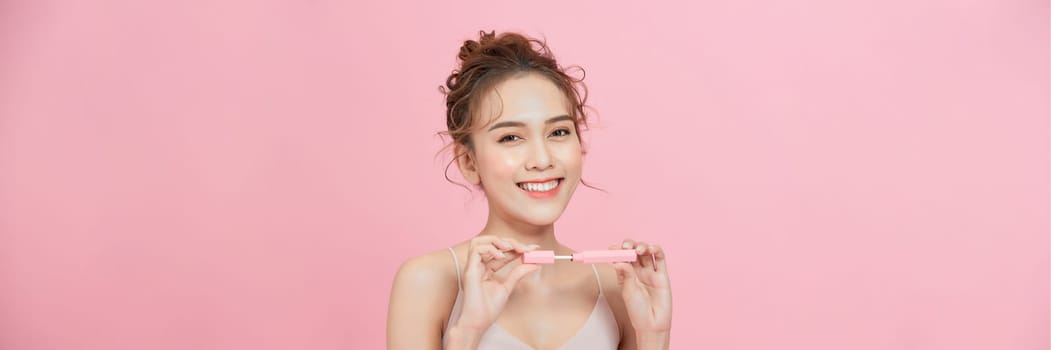 Photo of shirtless woman posing with lipstick, isolated studio background.