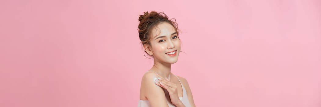 Banner of glamorous woman applying moisturizer cream on her arm for perfect skincare treatment