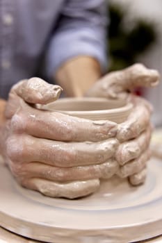 male hands making ceramic cup on pottery wheel, Close-up