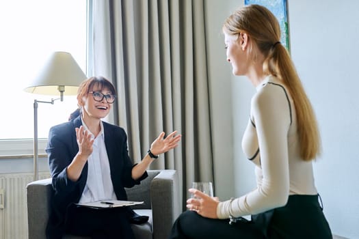 Mature female psychologist counselor therapist working with young woman sitting talking in office. Meeting therapy, psychology psychotherapy treatment support mental health concept