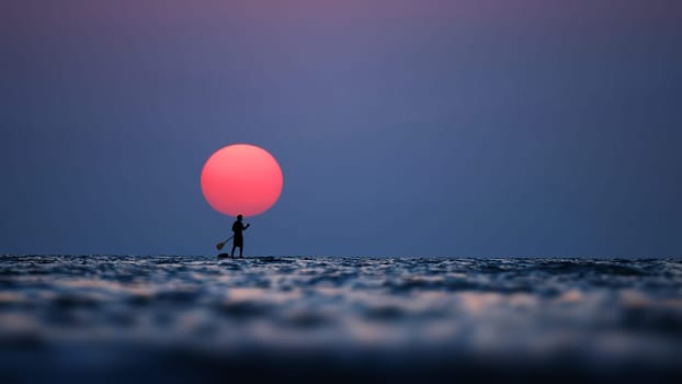 Silhouette of a man on the paddleboard against the setting sun. Paddleboard in the sea at sunset, side view . Young man on paddle boarding during a beautiful sunrise. Paddle-boarding in evening.