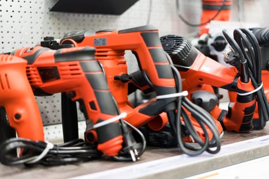 Power tools, drills and hammers of various manufacturers are sold in hardware store.