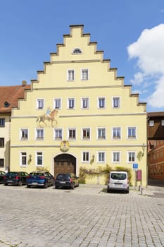 Feuchtwangen, Germany - May 6, 2023: Houses standing along the road, cars in the German town of Ansbach region.