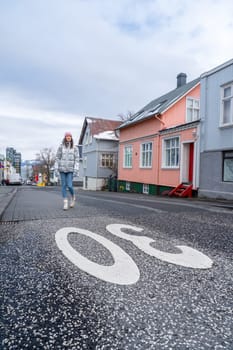 Woman with metallic silver coat on the streets of Reykjavik