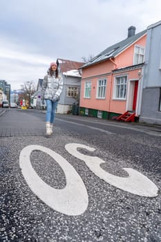 Woman with metallic silver coat on the streets of Reykjavik