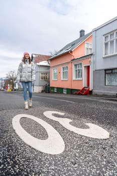 Woman with metallic silver coat on the streets of Reykjavik