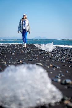 Woman walking on Diamond Beach, Iceland