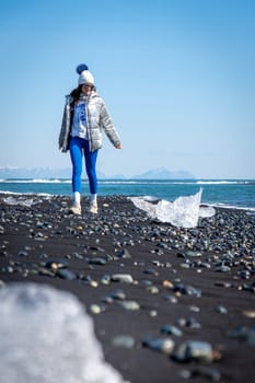 Woman walking on Diamond Beach, Iceland