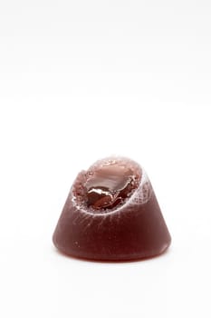 A closeup of cuberdon, a cone-shaped Belgian candy on a white background